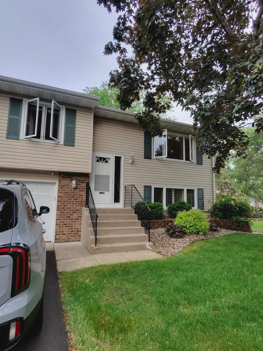 8365 100th St, Bloomington, MN 55438 - raised ranch with a front lawn and brick siding