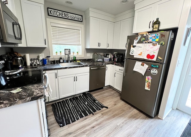 534 Main St, Perham, MN 56573 - kitchen with stainless steel appliances, white cabinets, and light wood-style flooring