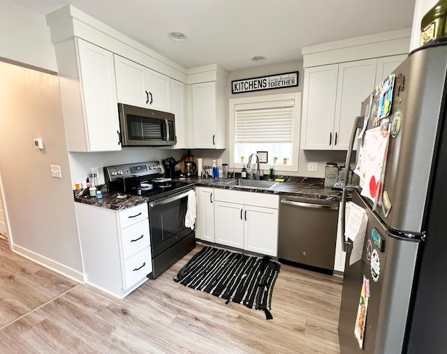 534 Main St, Perham, MN 56573 - kitchen featuring appliances with stainless steel finishes, light wood-style flooring, white cabinetry, and recessed lighting