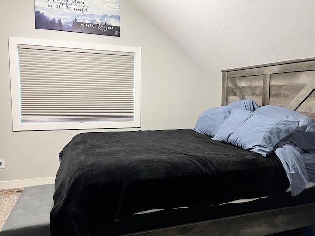534 Main St, Perham, MN 56573 - carpeted bedroom with lofted ceiling and baseboards