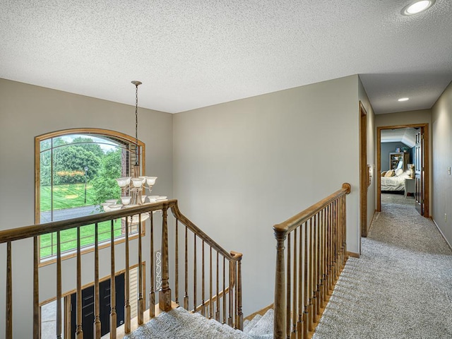 1847 140th Ln NE, Ham Lake, MN 55304 - stairway with carpet flooring, a textured ceiling, a chandelier, and recessed lighting