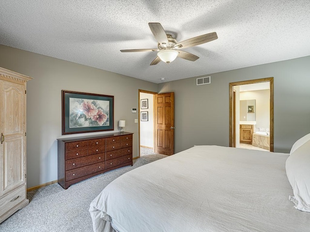 1847 140th Ln NE, Ham Lake, MN 55304 - bedroom with light carpet, a ceiling fan, ensuite bathroom, and a textured ceiling