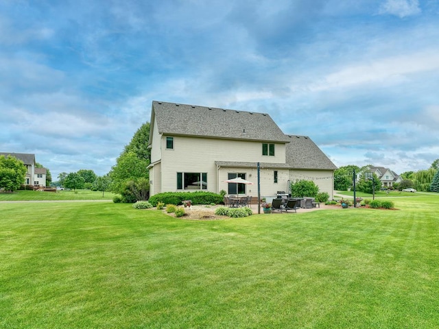 1847 140th Ln NE, Ham Lake, MN 55304 - back of house with a patio area, a lawn, and a shingled roof