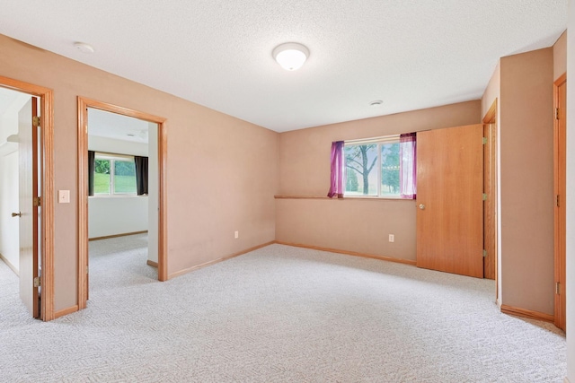 15616 84th St NE, Otsego, MN 55330 - unfurnished bedroom with multiple windows, carpet, and a textured ceiling