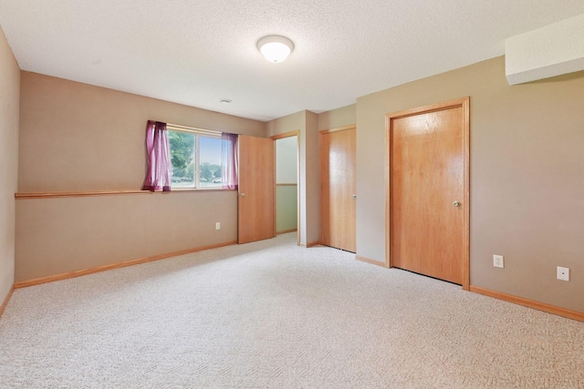 15616 84th St NE, Otsego, MN 55330 - unfurnished bedroom featuring carpet flooring, multiple closets, and a textured ceiling