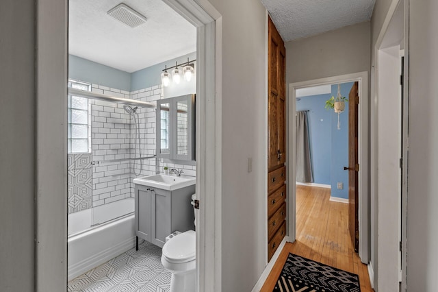3521 26th St, Minneapolis, MN 55406 - full bathroom featuring vanity, shower / washtub combination, a textured ceiling, and wood finished floors