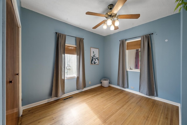 3521 26th St, Minneapolis, MN 55406 - spare room featuring wood-type flooring and ceiling fan
