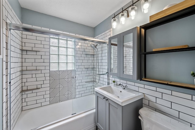 3521 26th St, Minneapolis, MN 55406 - bathroom with shower / bath combination with glass door, vanity, and tile walls