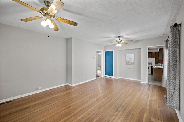 3521 26th St, Minneapolis, MN 55406 - unfurnished living room with ceiling fan, light wood finished floors, and a textured ceiling