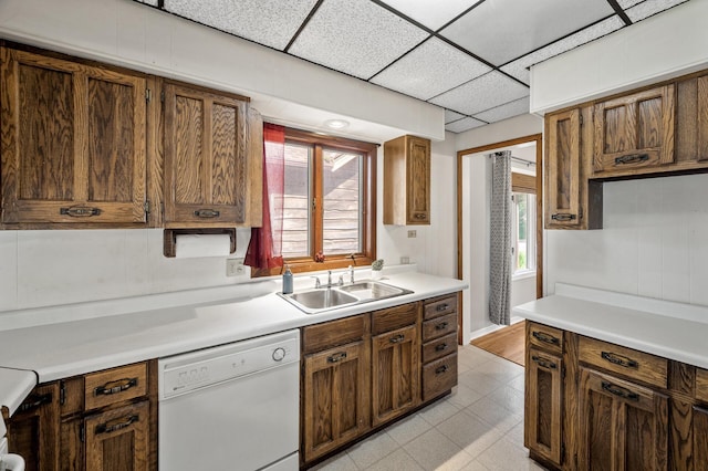 3521 26th St, Minneapolis, MN 55406 - kitchen with white dishwasher, light countertops, a drop ceiling, and light flooring