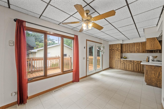 3521 26th St, Minneapolis, MN 55406 - kitchen featuring brown cabinets, light countertops, a paneled ceiling, premium range hood, and ceiling fan
