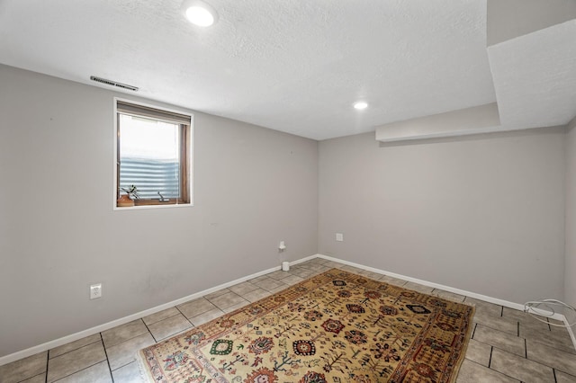 3521 26th St, Minneapolis, MN 55406 - basement with tile patterned floors, a textured ceiling, and recessed lighting