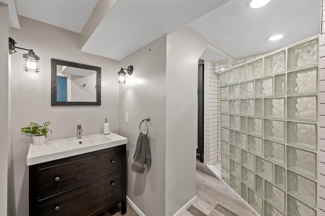 3521 26th St, Minneapolis, MN 55406 - bathroom with a walk in shower, vanity, wood finished floors, and recessed lighting
