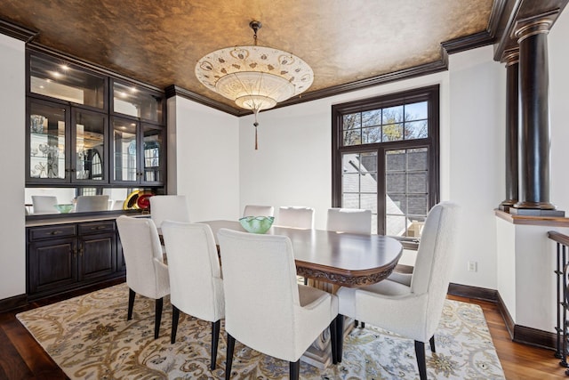 1709 1/2 Pulaski Rd, Buffalo, MN 55313 - dining room with decorative columns, dark wood-style floors, and crown molding