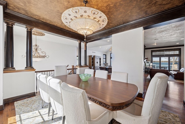 1709 1/2 Pulaski Rd, Buffalo, MN 55313 - dining space with ornate columns, wood finished floors, a tray ceiling, and crown molding