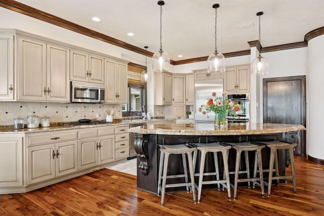 1709 1/2 Pulaski Rd, Buffalo, MN 55313 - kitchen featuring stainless steel appliances, ornamental molding, a center island, a kitchen breakfast bar, and dark wood-style flooring