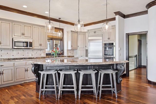 1709 1/2 Pulaski Rd, Buffalo, MN 55313 - kitchen with stainless steel appliances, a breakfast bar, a kitchen island, tasteful backsplash, and ornamental molding