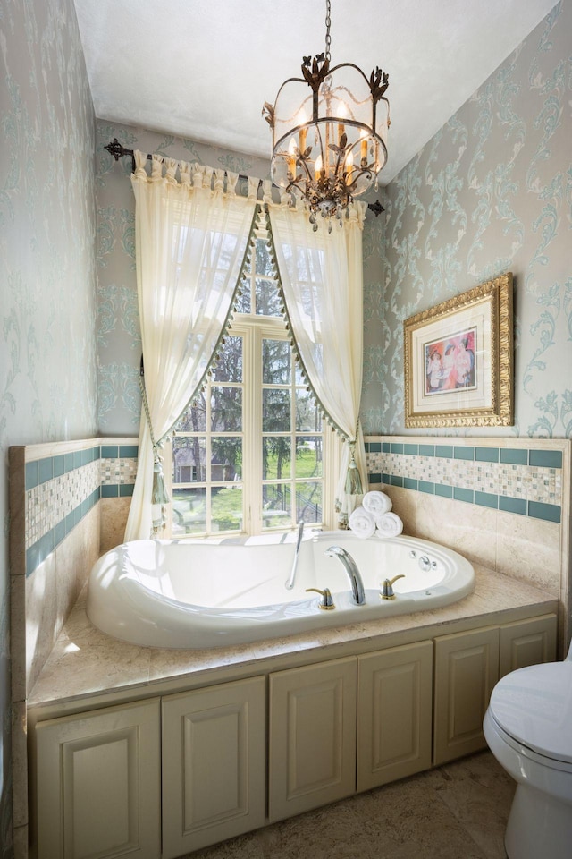 1709 1/2 Pulaski Rd, Buffalo, MN 55313 - bathroom with wallpapered walls, a chandelier, a bath, and a wainscoted wall