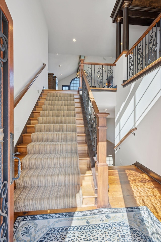 1709 1/2 Pulaski Rd, Buffalo, MN 55313 - staircase with high vaulted ceiling, wood finished floors, and recessed lighting