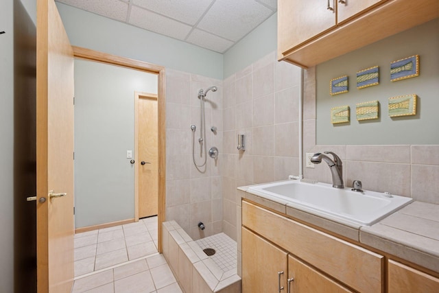 1709 1/2 Pulaski Rd, Buffalo, MN 55313 - full bathroom with a paneled ceiling, tiled shower, tile patterned floors, vanity, and tile walls