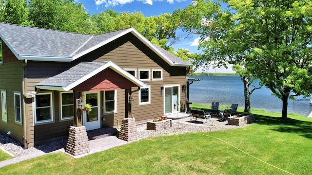 45207 281st Ln, Aitkin, MN 56431 - back of property featuring roof with shingles, a lawn, a water view, and a fire pit