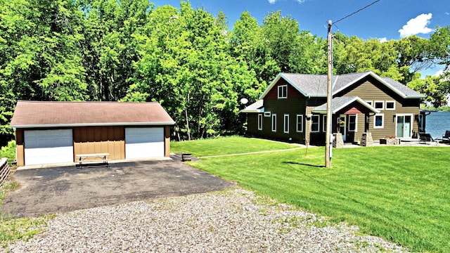 45207 281st Ln, Aitkin, MN 56431 - view of front of property featuring a detached garage, an outbuilding, and a front yard