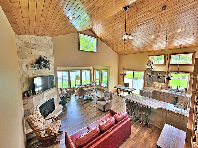 45207 281st Ln, Aitkin, MN 56431 - living area featuring a fireplace, wood ceiling, ceiling fan, wood finished floors, and a chandelier