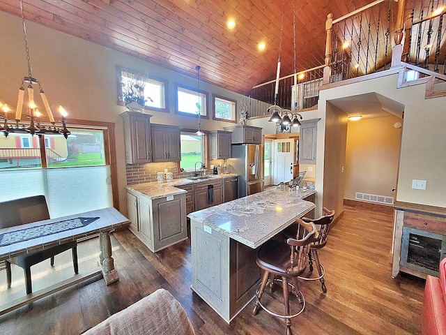 45207 281st Ln, Aitkin, MN 56431 - kitchen featuring stainless steel fridge, gray cabinets, wood ceiling, high vaulted ceiling, and a chandelier
