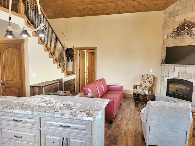 45207 281st Ln, Aitkin, MN 56431 - kitchen featuring open floor plan, a stone fireplace, dark wood finished floors, wood ceiling, and high vaulted ceiling