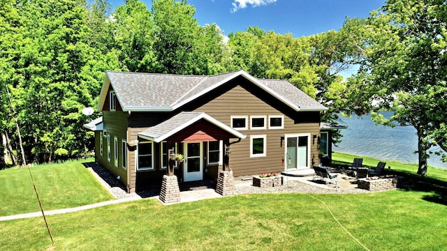 45207 281st Ln, Aitkin, MN 56431 - back of property with a yard, a water view, a shingled roof, a patio area, and an outdoor fire pit