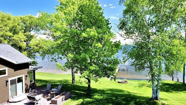 45207 281st Ln, Aitkin, MN 56431 - view of green lawn with a fire pit and a patio area