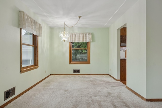 1864 Morgan Ave, Saint Paul, MN 55116 - carpeted spare room with plenty of natural light and a chandelier