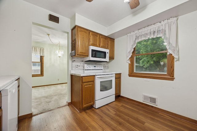 1864 Morgan Ave, Saint Paul, MN 55116 - kitchen featuring white appliances, brown cabinets, dark wood-style flooring, and plenty of natural light