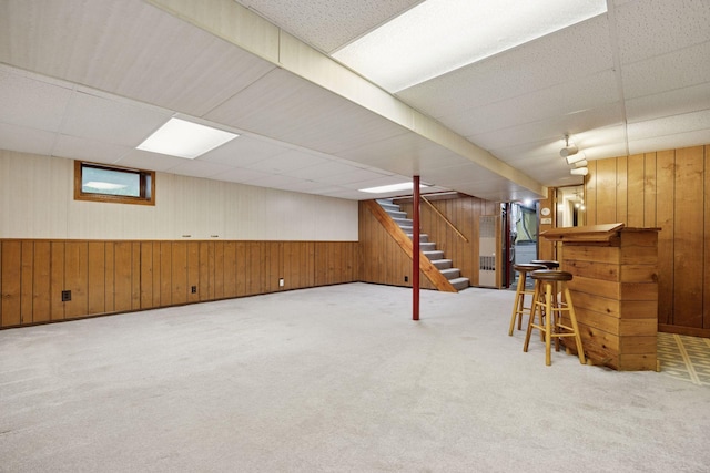 1864 Morgan Ave, Saint Paul, MN 55116 - below grade area with wood walls, stairway, carpet floors, a drop ceiling, and a bar