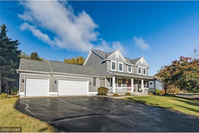 13 Echo Lake Blvd, Mahtomedi, MN 55115 - view of front of home with covered porch, asphalt driveway, an attached garage, and a front lawn