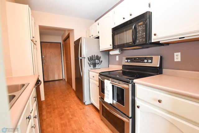2515 25th St S Unit 303H, Fargo, ND 58103 - kitchen featuring appliances with stainless steel finishes, white cabinets, light wood-style flooring, and light countertops