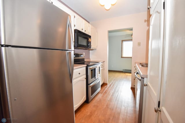 2515 25th St S Unit 303H, Fargo, ND 58103 - kitchen featuring appliances with stainless steel finishes, white cabinets, light countertops, light wood finished floors, and ceiling fan