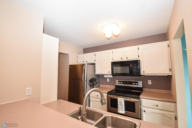 2515 25th St S Unit 303H, Fargo, ND 58103 - kitchen with appliances with stainless steel finishes, light countertops, and white cabinetry