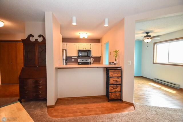 2515 25th St S Unit 303H, Fargo, ND 58103 - kitchen featuring black microwave, a baseboard heating unit, stove, freestanding refrigerator, and carpet