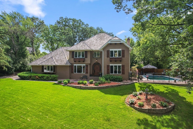 16209 Adeline Ln, Minnetonka, MN 55391 - view of front facade with stucco siding, a chimney, and a fenced backyard