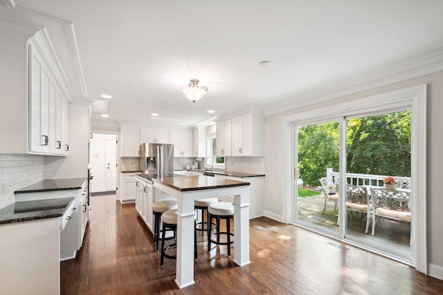16209 Adeline Ln, Minnetonka, MN 55391 - kitchen featuring stainless steel fridge, healthy amount of natural light, a kitchen island, white cabinets, and ornamental molding