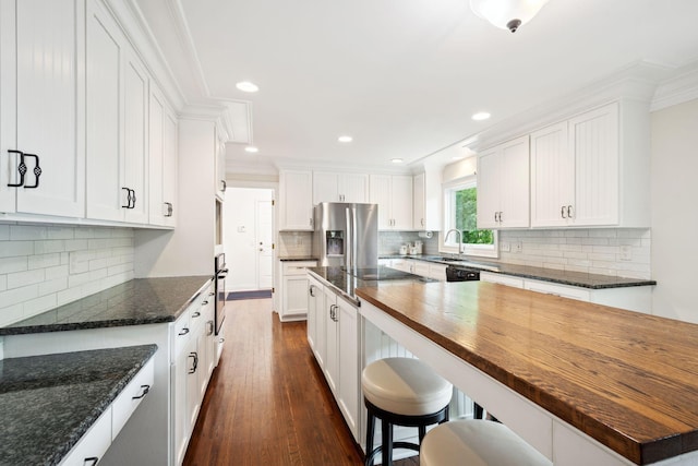 16209 Adeline Ln, Minnetonka, MN 55391 - kitchen featuring appliances with stainless steel finishes, dark wood-style floors, white cabinets, tasteful backsplash, and crown molding
