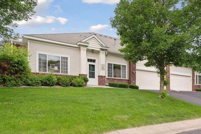 2014 Stahlke Way, Chaska, MN 55318 - view of front of house with driveway, a front lawn, brick siding, and a shingled roof