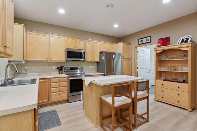 2014 Stahlke Way, Chaska, MN 55318 - kitchen featuring appliances with stainless steel finishes, light brown cabinets, light wood finished floors, decorative backsplash, and light countertops