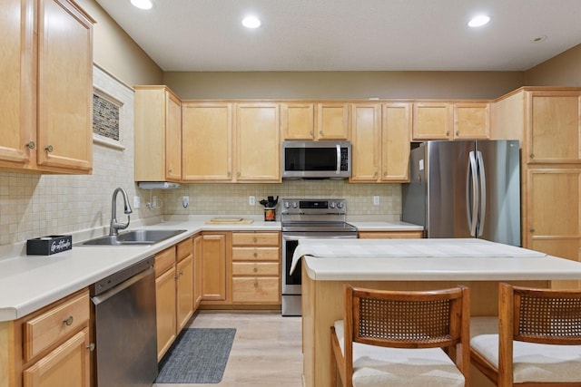 2014 Stahlke Way, Chaska, MN 55318 - kitchen with stainless steel appliances, light brown cabinets, light wood-type flooring, recessed lighting, and decorative backsplash