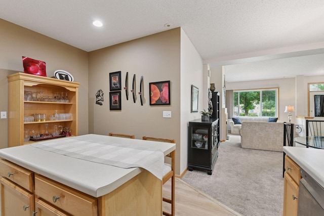 2014 Stahlke Way, Chaska, MN 55318 - kitchen featuring dishwasher, open floor plan, light countertops, a breakfast bar area, and recessed lighting