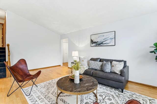382 Tuttle Dr, Hastings, MN 55033 - living area featuring light wood-style floors, lofted ceiling, and stairway