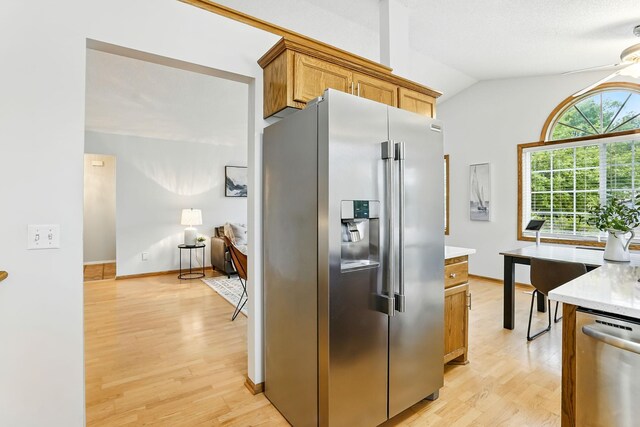 382 Tuttle Dr, Hastings, MN 55033 - kitchen with stainless steel appliances, light wood finished floors, vaulted ceiling, and brown cabinets