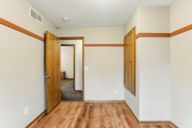 382 Tuttle Dr, Hastings, MN 55033 - spare room with light wood-style floors and a textured ceiling