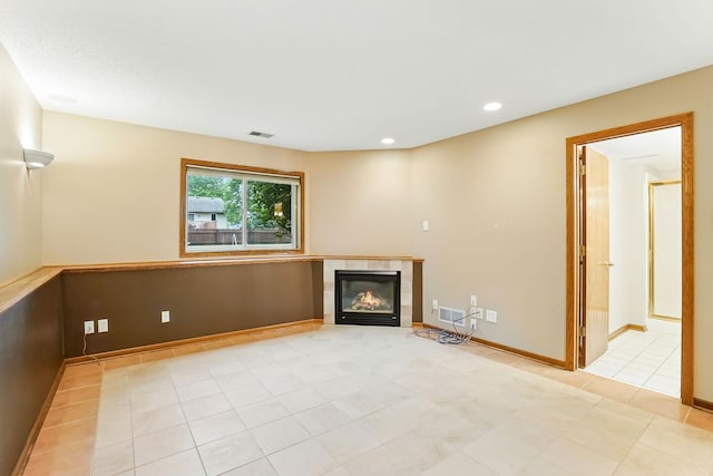 382 Tuttle Dr, Hastings, MN 55033 - unfurnished living room featuring a tile fireplace, light tile patterned floors, and recessed lighting